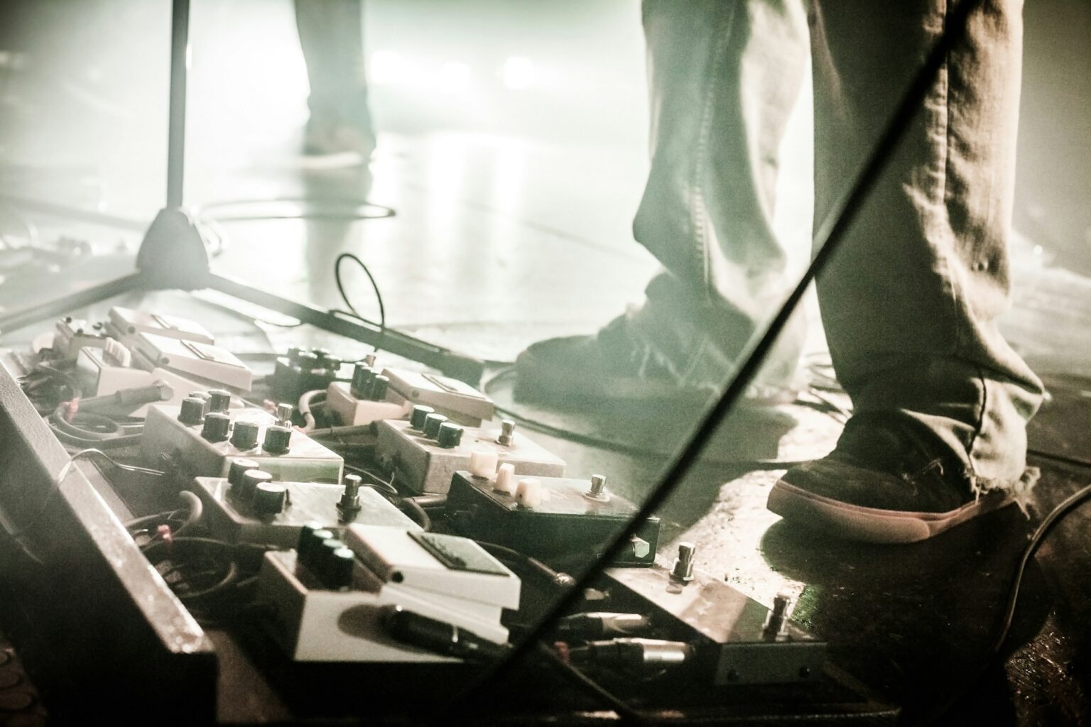 Guitar Pedals on a stage with live band performing during a Show